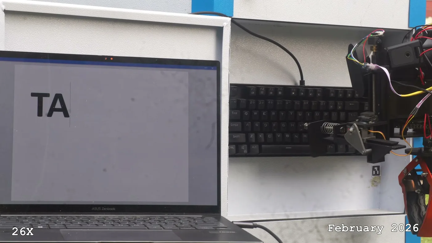 Taurus typing on a servicing keyboard with the dedicated clicker end effector